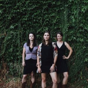 five letter word band in front of ivy-covered walls