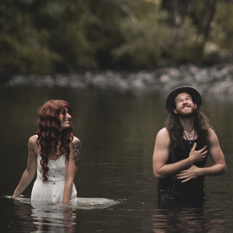 Musicians fox and bones swimming in a lake